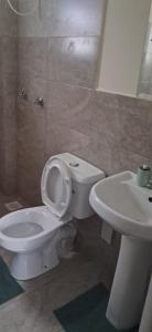 a bathroom with a white toilet and a sink at 3C Palm Ridge Vipingo in Kilifi