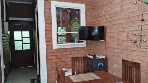 a wall with a tv on a brick wall at Villa Sol in Kamburugamuwa