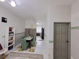 a hallway with a room with a table and a door at Homestay nakhoda Sitiawan in Lumut