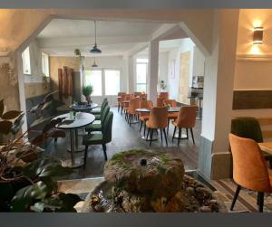 a restaurant with tables and chairs in a room at Apartmani BALKAN in Sjenica