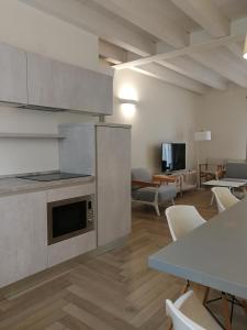 a kitchen and living room with a table and chairs at Residence Atlantico in Lido di Jesolo