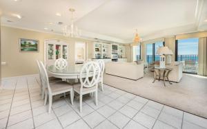 a dining room and living room with a table and chairs at Phoenix East 1401 in Orange Beach