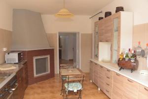 a large kitchen with a table and a counter top at Villa Alessandro in Poggiardo +5 photos