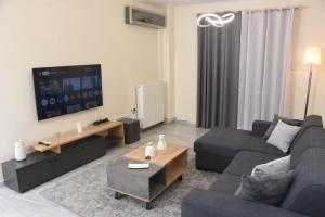 a living room with a couch and a tv at Sparta Central Apartment with Free Parking in Sparta