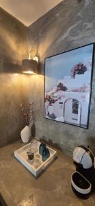 a room with a tv on a wall with a table at La Perle du Voyageur in Agde