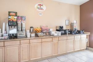 a counter in a coffee shop with a coffee machine at Super 8 by Wyndham Spokane Valley in Spokane Valley