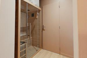 a walk in closet with a glass door at Le Spa by SCH in Le Havre