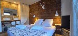 a bedroom with a bed and a bathroom with a sink at La Perle du Voyageur in Agde +29 photos