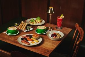 a table with three plates of food on it at Bankes Arms Hotel in Wareham