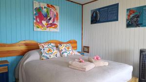 a bedroom with a bed with towels on it at Kuhane Etno-Hostal in Hanga Roa +8 photos