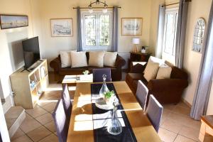 a living room with a couch and a table at Aegina3views in Kipséli