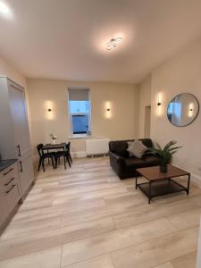 a living room with a couch and a table at Rambler's Rest Boutique Apartment in Westward Ho