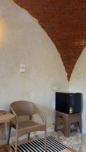a living room with a chair and a television at Nour El wadi in Siwa