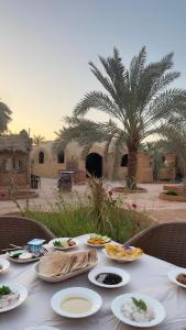 a table with plates of food on top of it at Nour El wadi in Siwa