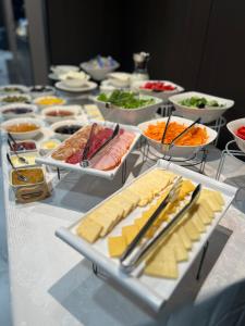 a table with cheese and other appetizers and other foods at BM Avenue Hotel in Yerevan