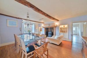 a dining room and living room with a table and chairs at Old Ford House in Blandford Forum