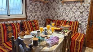 a table with food and drinks on top at Tidmi Wave Anza in Agadir