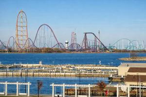 a group of roller coasters on the water at Mario Room Waterfront Downtown View Cedar Point! in Sandusky +82 photos