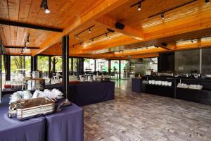 a restaurant with purple tables and counters in a building at The Grace Amphawa in Amphawa