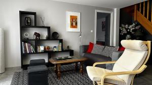 a living room with a couch and a table at Gîte des voines in Maillé