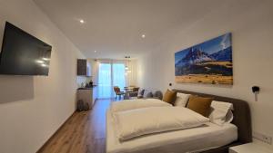 a living room with two beds and a couch at ecHo Apartments & SPA in Bressanone