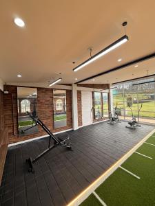 a gym with treadmills and ellipticals in a building at Hotel La Libertad in Paipa