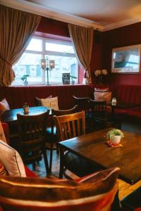 a restaurant with tables and chairs and a window at The White House Inn - Whitby in Whitby +58 photos