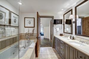 a bathroom with two sinks and a tub at The Arrabelle at Vail Square, a RockResort, by Vail Resorts in Vail +210 photos