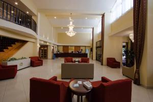 a lobby of a hospital with red chairs and tables at Ramada by Wyndham Houston Intercontinental Airport East in Humble