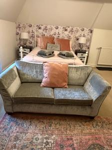 a couch in a living room with a bed at The Dairyman Suite in Dorchester