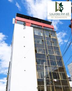 a tall white building with a lot of windows at LourdesInn65 in Bogotá