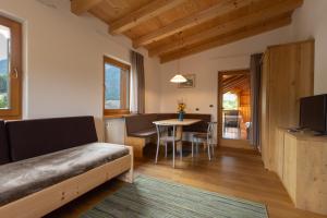 a living room with a couch and a table at Cone da Val in San Vigilio Di Marebbe