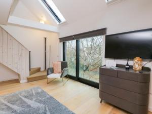 a living room with a large flat screen tv at 3 The Stoneyard in Bath