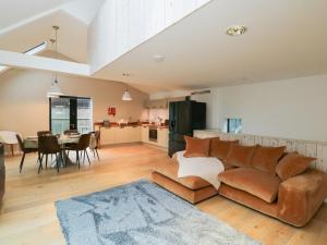 a living room with a couch and a dining room at 3 The Stoneyard in Bath