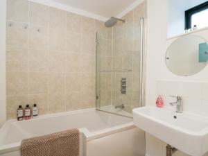 a bathroom with a tub and a sink and a shower at 3 The Stoneyard in Bath +26 photos