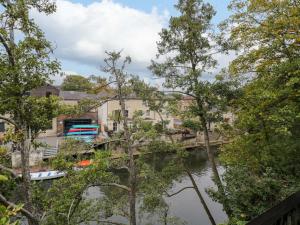 a bridge over a river with trees at 3 The Stoneyard in Bath