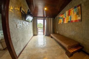 a hallway with a bench in a room with a window at Contemporary architecture by the sea in Búzios