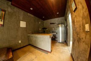 a kitchen with a counter and a refrigerator at Contemporary architecture by the sea in Búzios