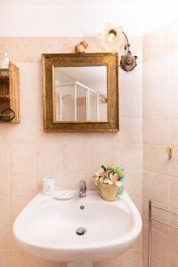 a bathroom with a sink and a mirror at LA GROTTA Guest House Subiaco in Subiaco