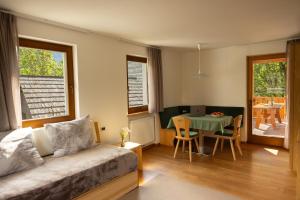 a living room with a bed and a table with a dining room at Cone da Val in San Vigilio Di Marebbe +32 photos