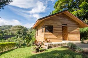 małą drewnianą kabinę z drzwiami na dziedzińcu w obiekcie Cabañas Hoja Verde w mieście Monteverde
