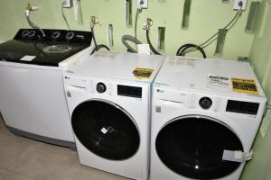two washing machines sitting next to each other in a room at Duncan Street Guesthouse in Georgetown