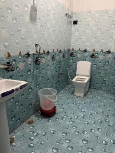 a bathroom with a sink and a toilet at Hotel prayagraj in Barkot