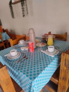 a table with a blue table cloth on top of it at Pouso Clara Mar in Paraty +22 photos