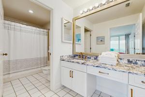 a bathroom with a sink and a mirror at Navarre Beach Regency 203 in Navarre +10 photos