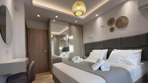 a bedroom with a large bed and a mirror at Tago Houses in Elafonisos