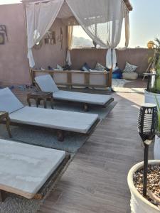 a group of beds in a room with a tent at Abrid Surf in Tamraght Ouzdar