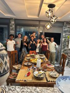 a group of people standing around a table at Abrid Surf in Tamraght Ouzdar +78 photos