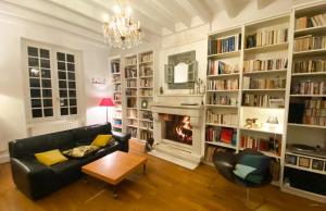 a living room with a couch and a fireplace at Les forts in Leigné-les-Bois