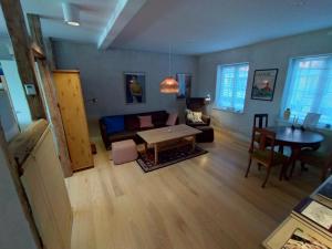 a living room with a couch and a table at PilgrimsHuset Maribo in Maribo